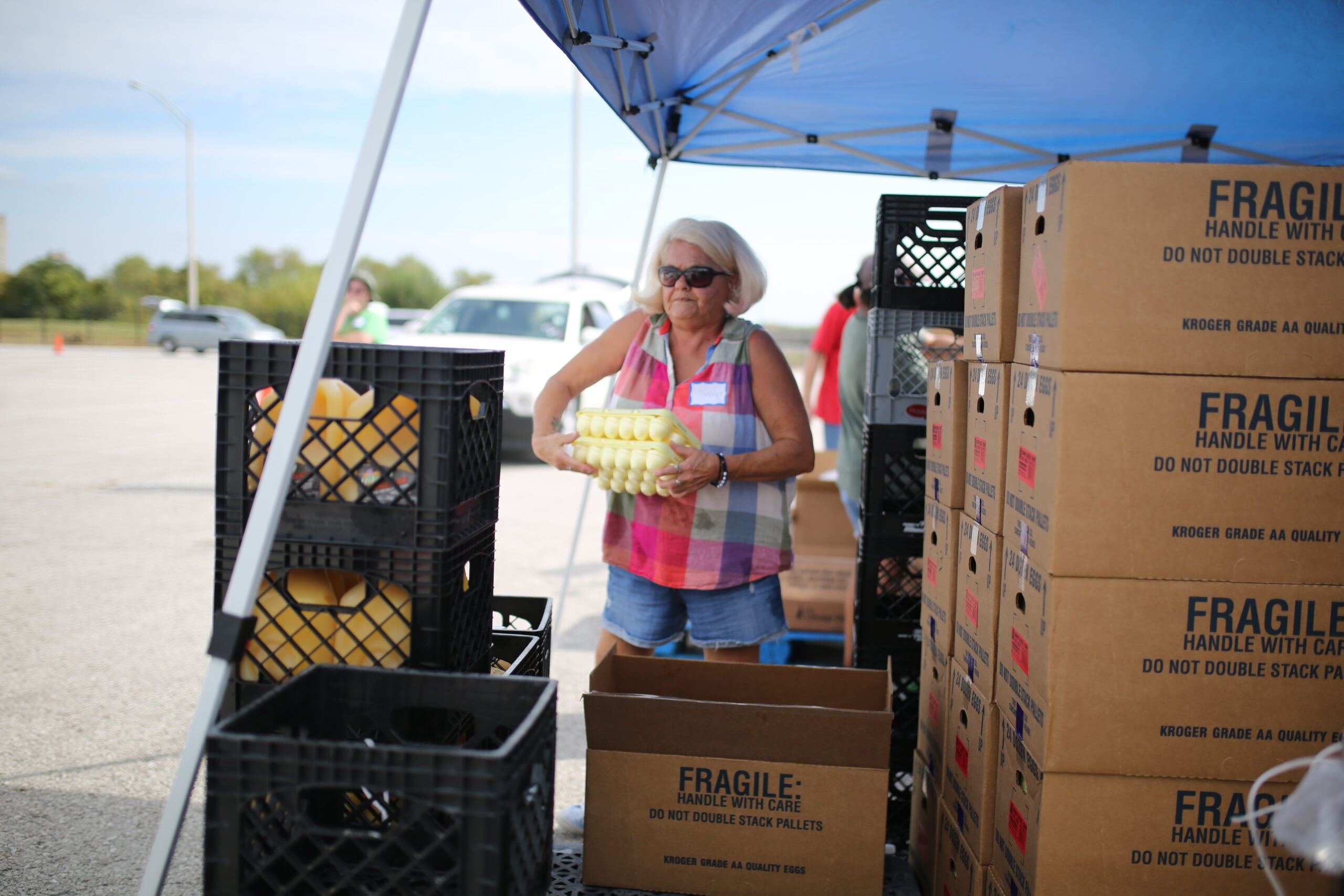 Volunteer sorting free food at a Mobile Food Distribution event.