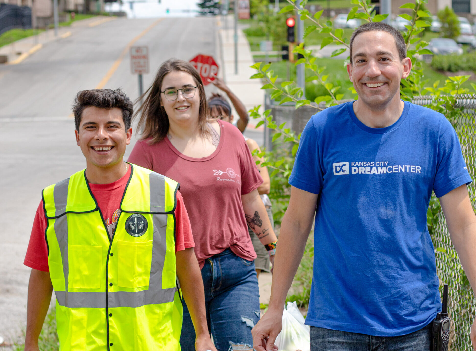 Volunteers smiling and walking through a neighborhood.